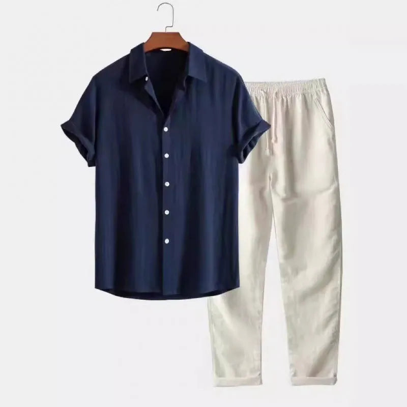 Man wearing grey blue loose short sleeve shirt and matching trousers from casual suit set