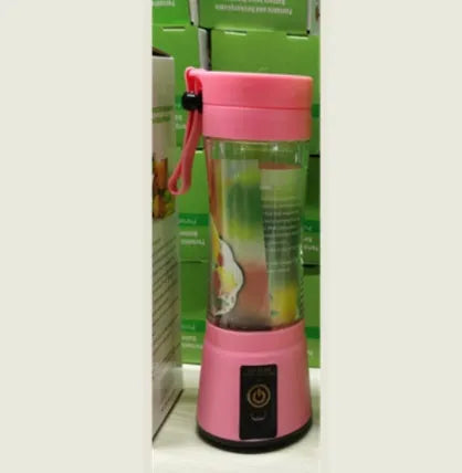 Pink portable USB rechargeable blender with 380ml cup on a table next to fruits.