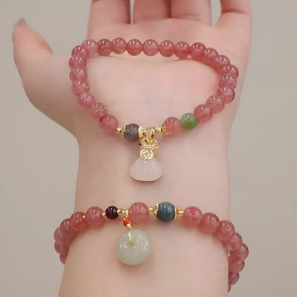 Natural strawberry quartz women's bracelet with geometric design, peace buckle closure, and lucky bagg purse charm attachment