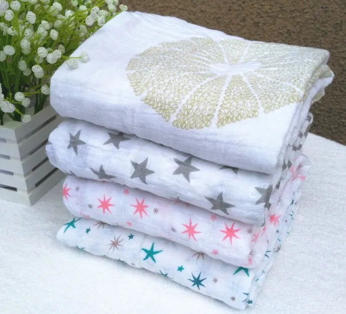 Cotton gauze baby blanket 120x120cm in balloon elephant style folded on a light background