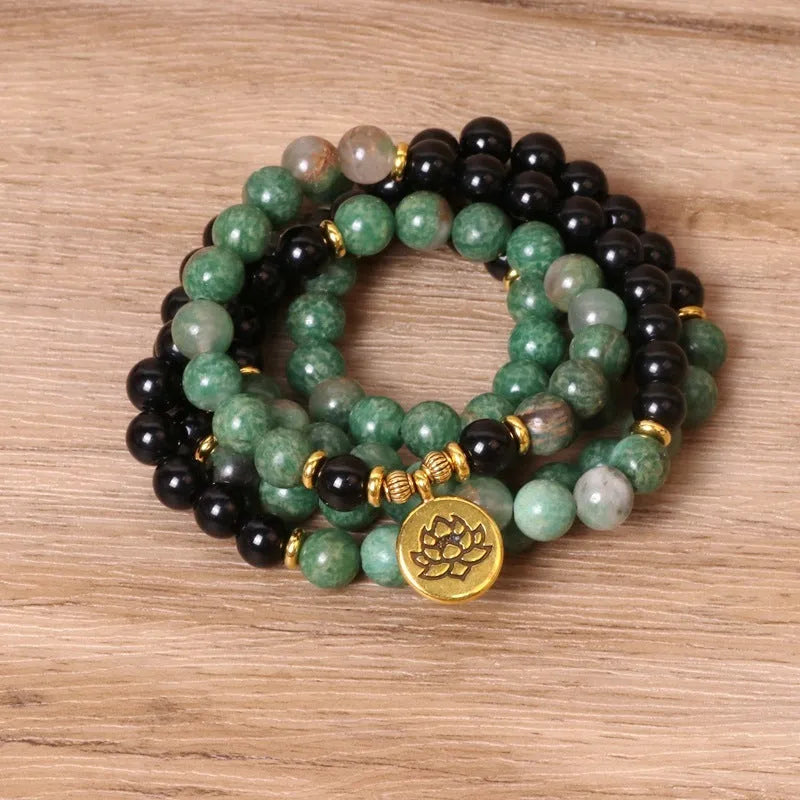 Green and black alloy elastic beaded bracelet with natural styling on wrist