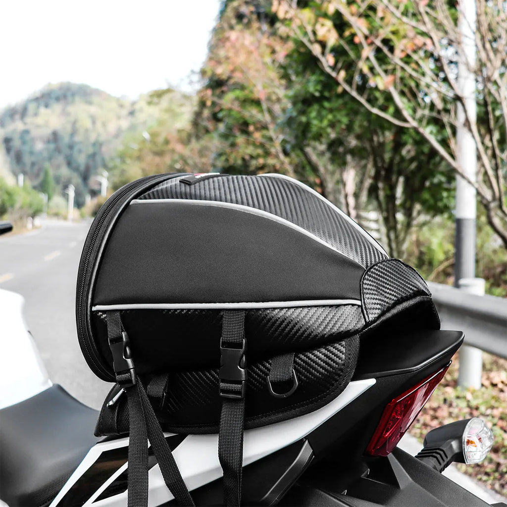 Black waterproof motorcycle seat bag with reflective strips, measuring 30x28x21cm with convertible crossbody strap