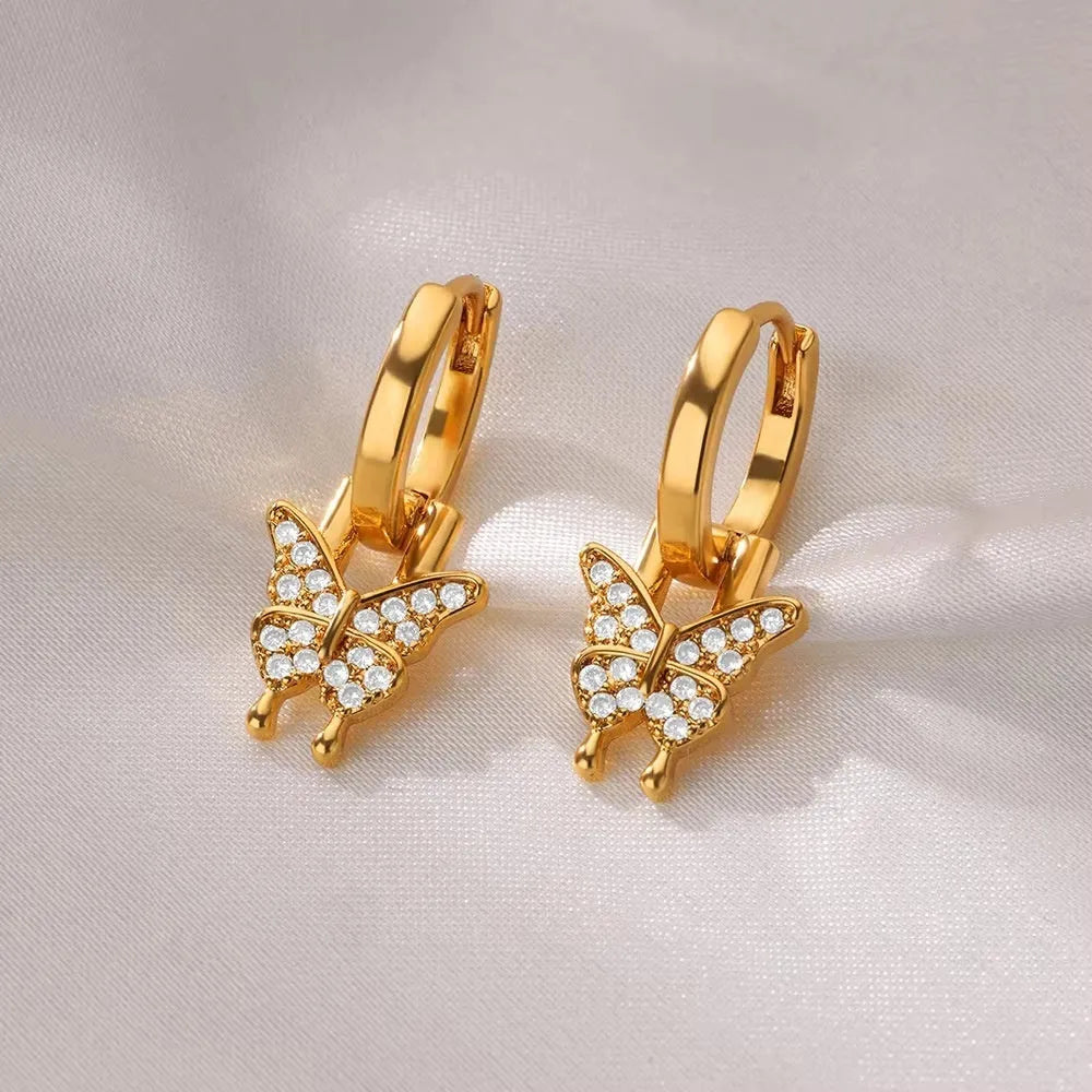 Geometric butterfly earrings with heart and star shapes in copper with diamond treatment