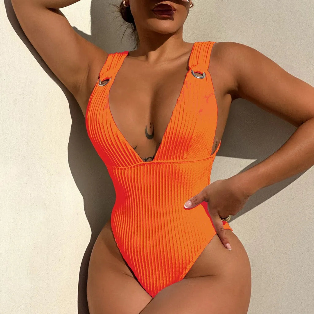 Women's solid colour one-piece swimsuit on a hanger in black, white, green, and orange.