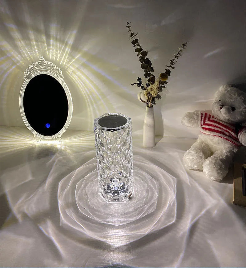 LED rose diamond shaped table lamp with acrylic construction and three-tone lighting on a wooden surface.