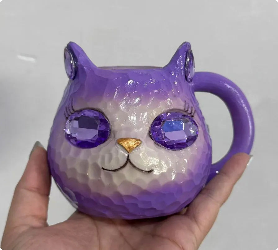Colourful resin Crystal Earth Cat Cup craft decorative gift on a table.