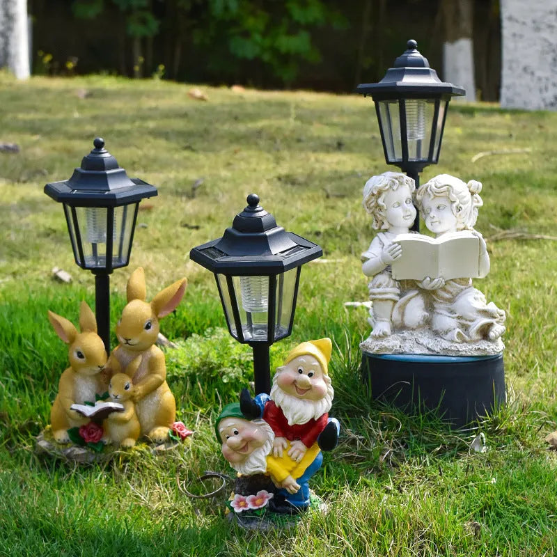 Hexagonal solar garden lamp with decorative resin animal design on grass