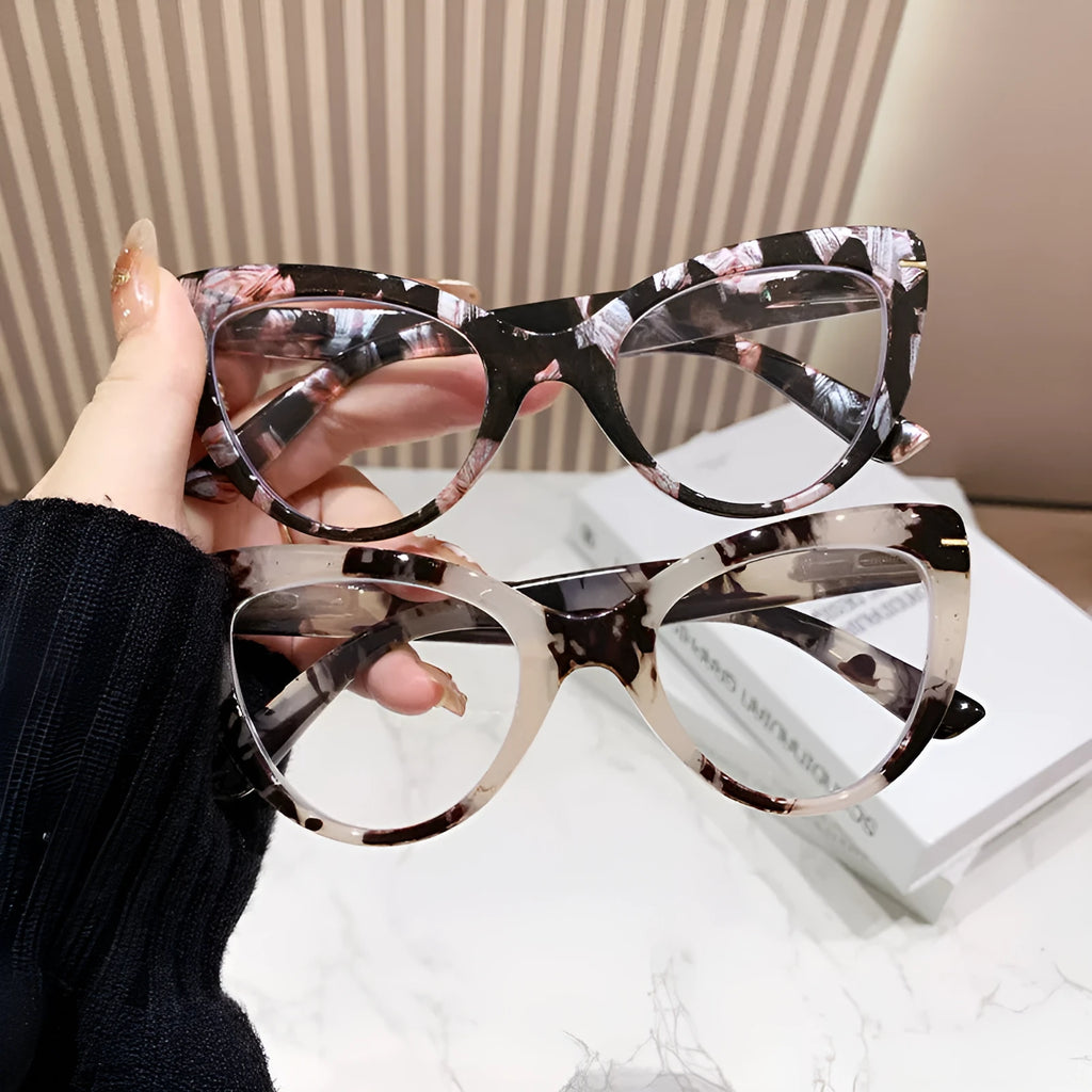 Women's large cat's eye frame glasses with dragon and phoenix decorations, shown in various colour options.