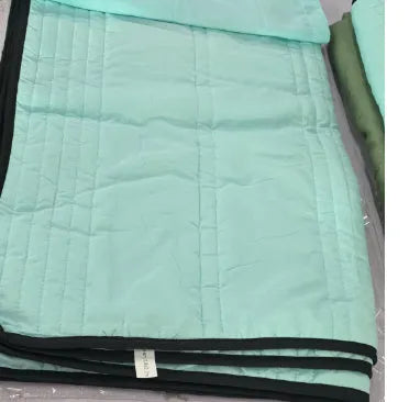 Pure colour seersucker cooling air-conditioning quilt laid flat on a bed