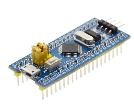 STM32F103C8T6 ARM microcontroller development board with Mini USB connector and pin headers.