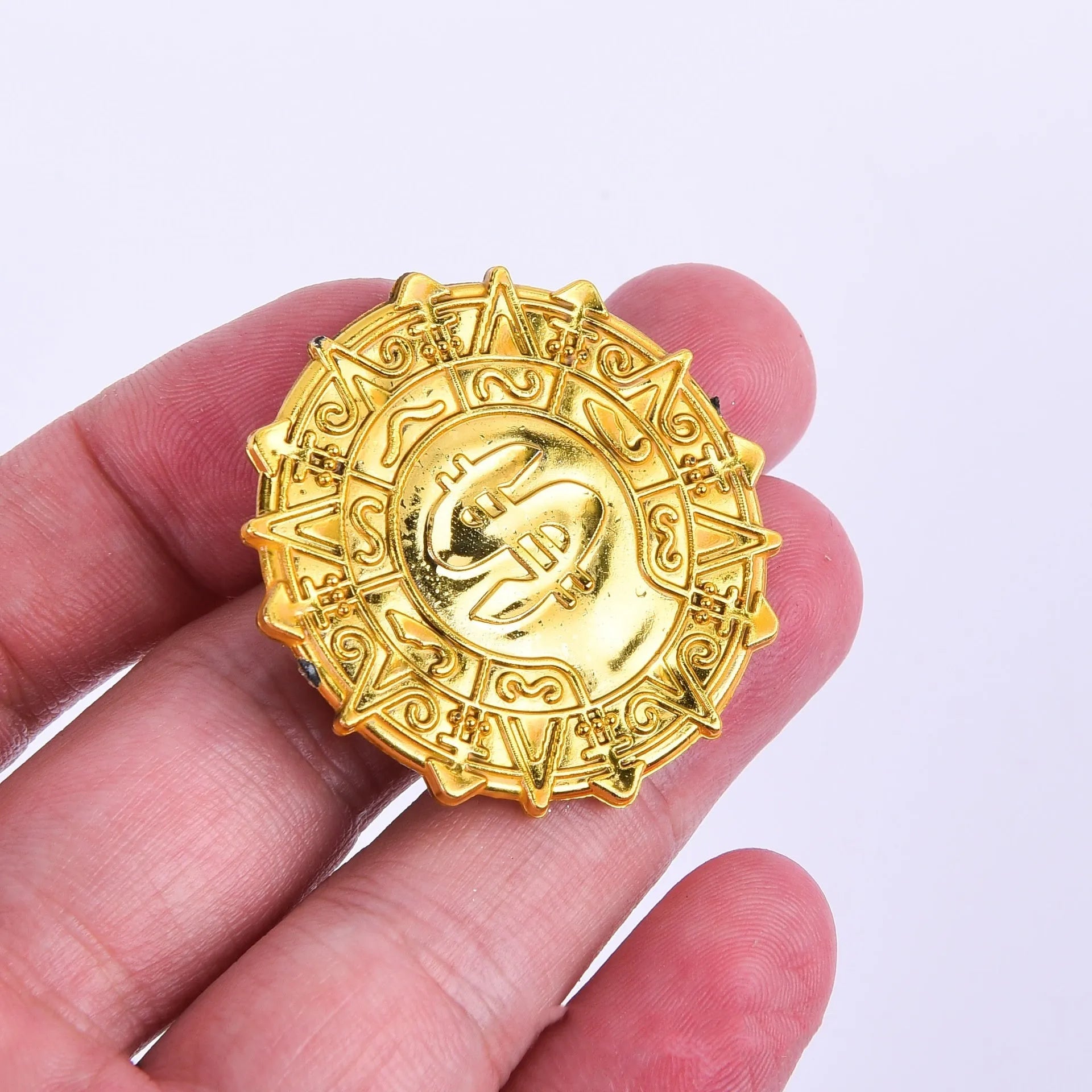 Plastic pirate gold coin with pointed tip styling measuring 3.6cm diameter