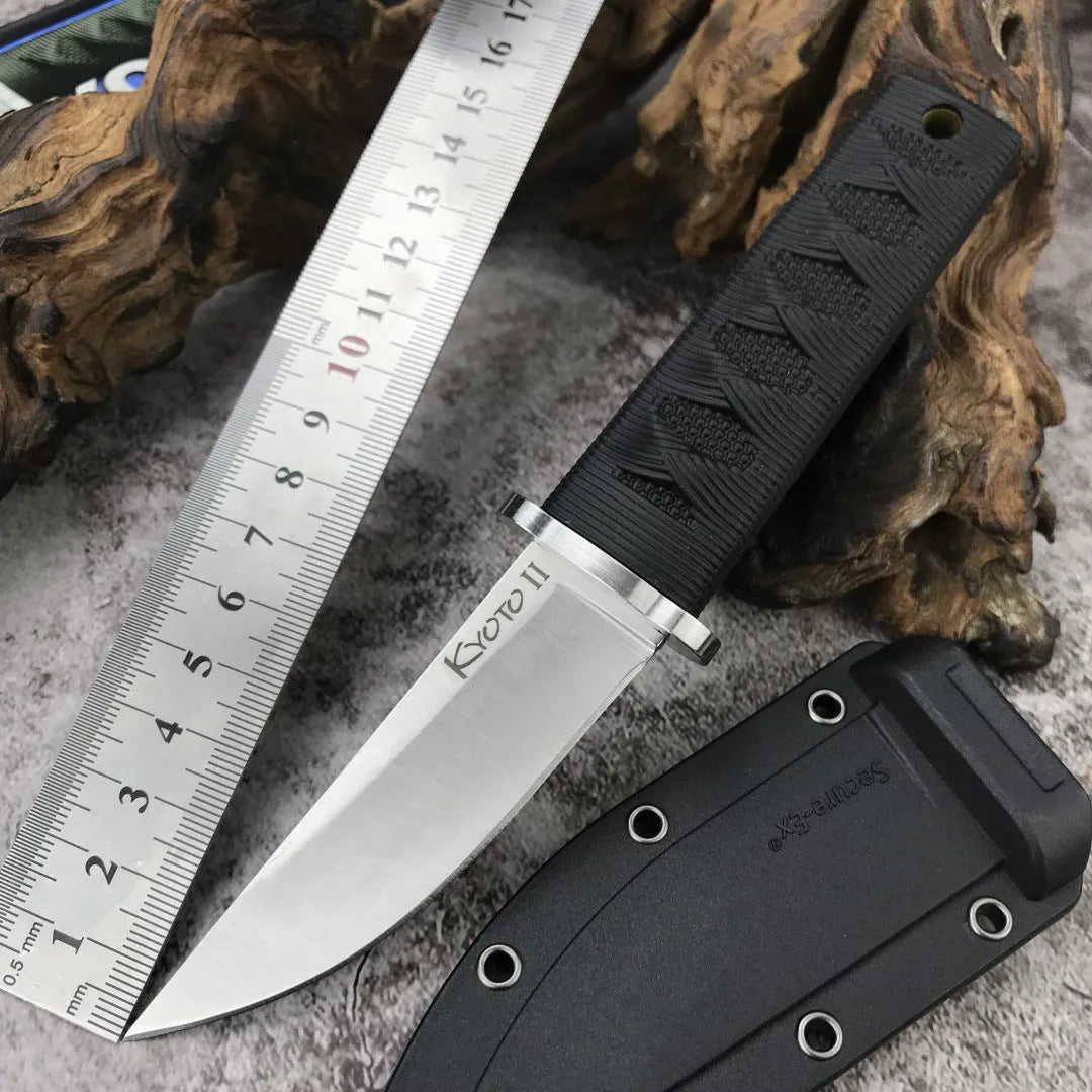 Mini fixed blade knife with 440C steel blade and ABS handle on a wooden surface