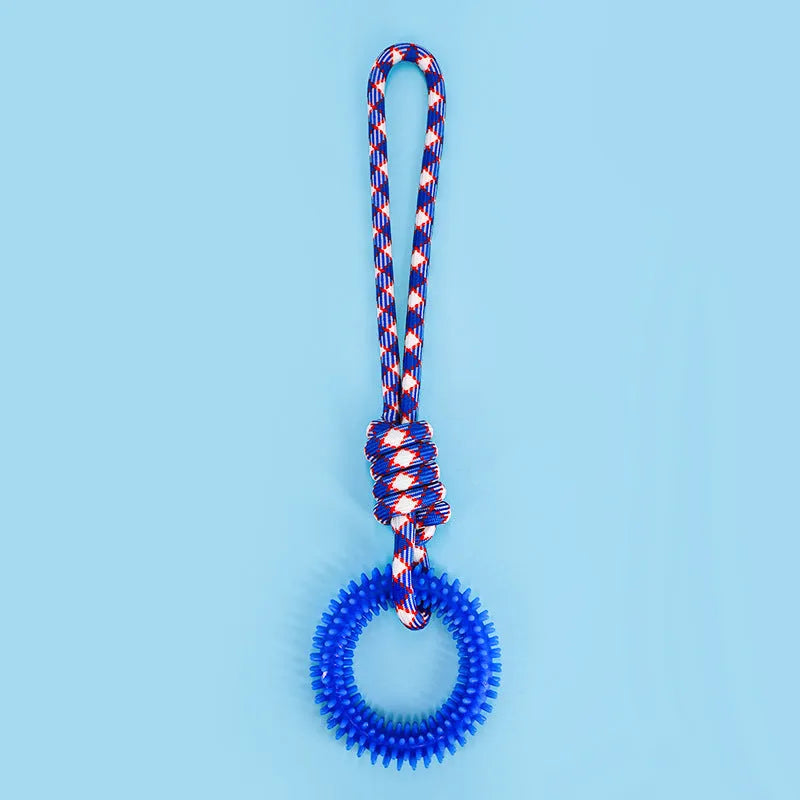 Blue braided rope dog chew toy with a large central knot on a wooden floor