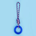 Blue braided rope dog chew toy with a large central knot on a wooden floor
