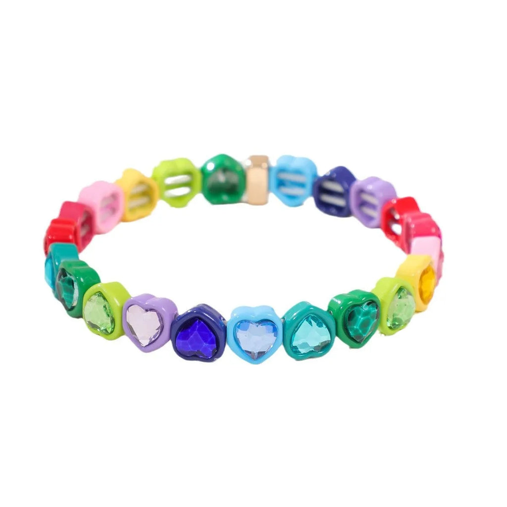 Colourful enamel heart-shaped charm on a stretch bracelet with diamond-textured alloy finish.