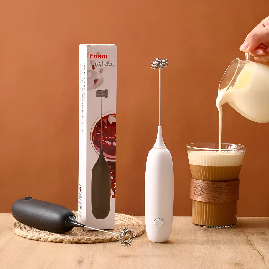 Black and white hand-held electric milk frother blender on kitchen counter