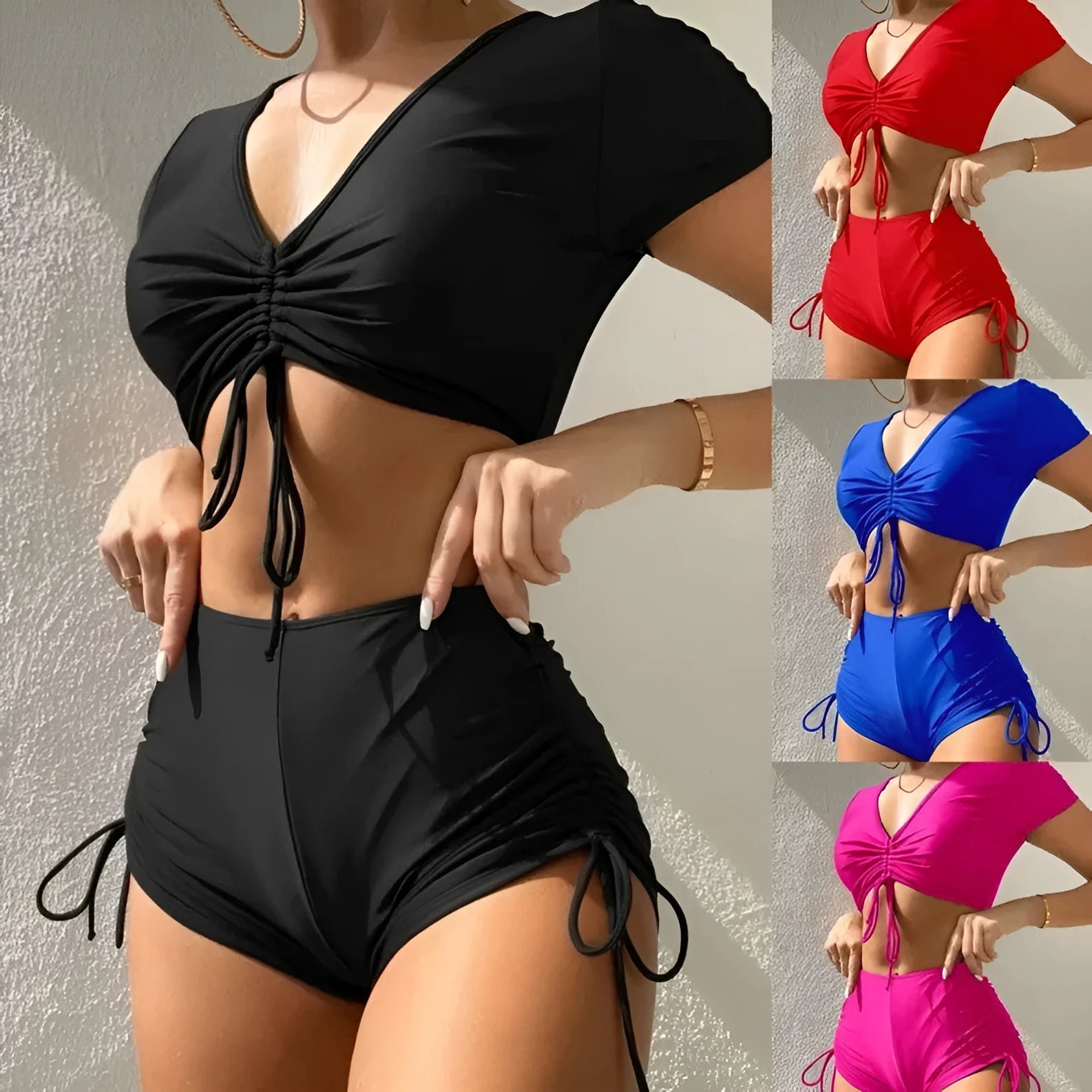 Women's black lace-up swimsuit with bow detail, showing top and shorts set.