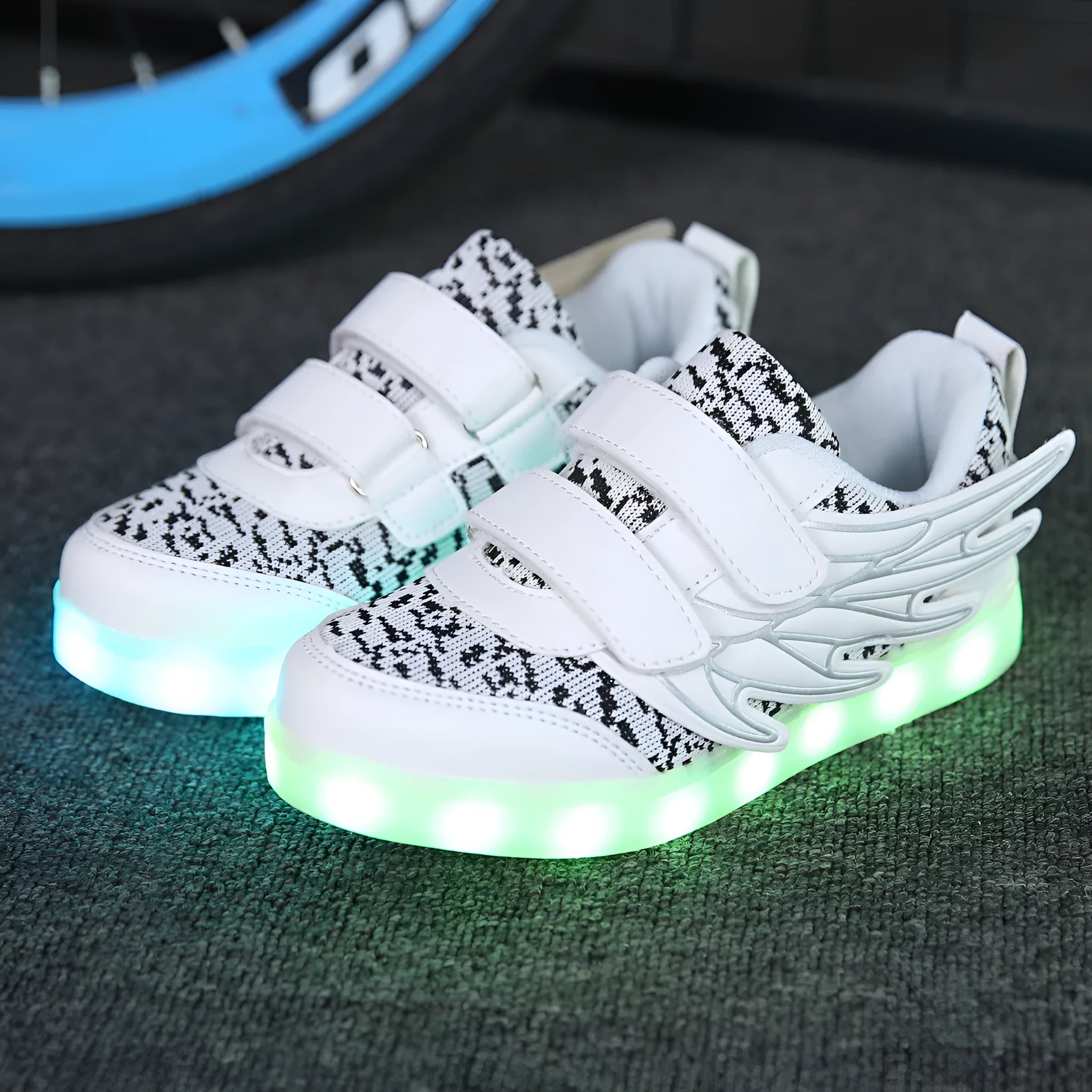 Children's plum red and white LED light-up sneakers with USB charging port visible.