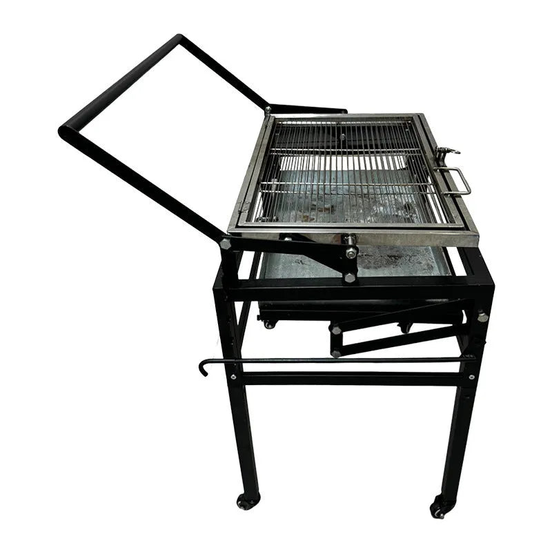 Large foldable charcoal barbecue oven set up in a garden for grilling.