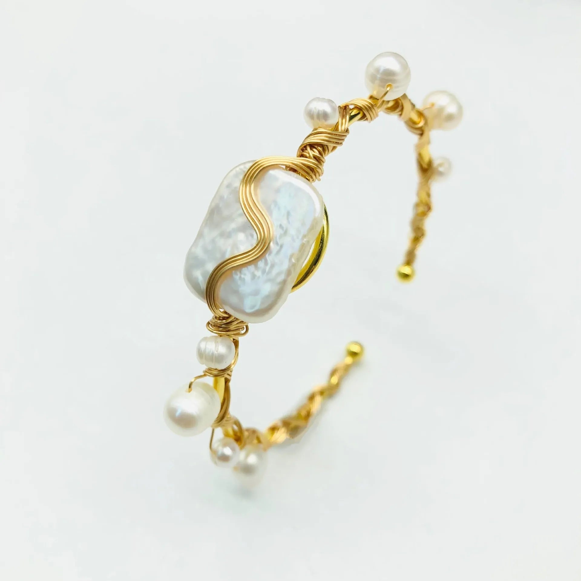 Natural freshwater pearl handmade wire-wrapped bracelet in gold titanium steel on wrist