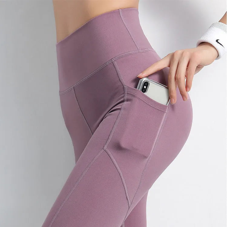 Sports leggings with pockets for women in chemical fibre blend polyester and spandex, available in navy black purple blue sizes S M L XL, suitable for body building across all seasons