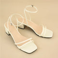 Beige women's sandals with a stiletto chunky heel, square toe, and a single ankle buckle.