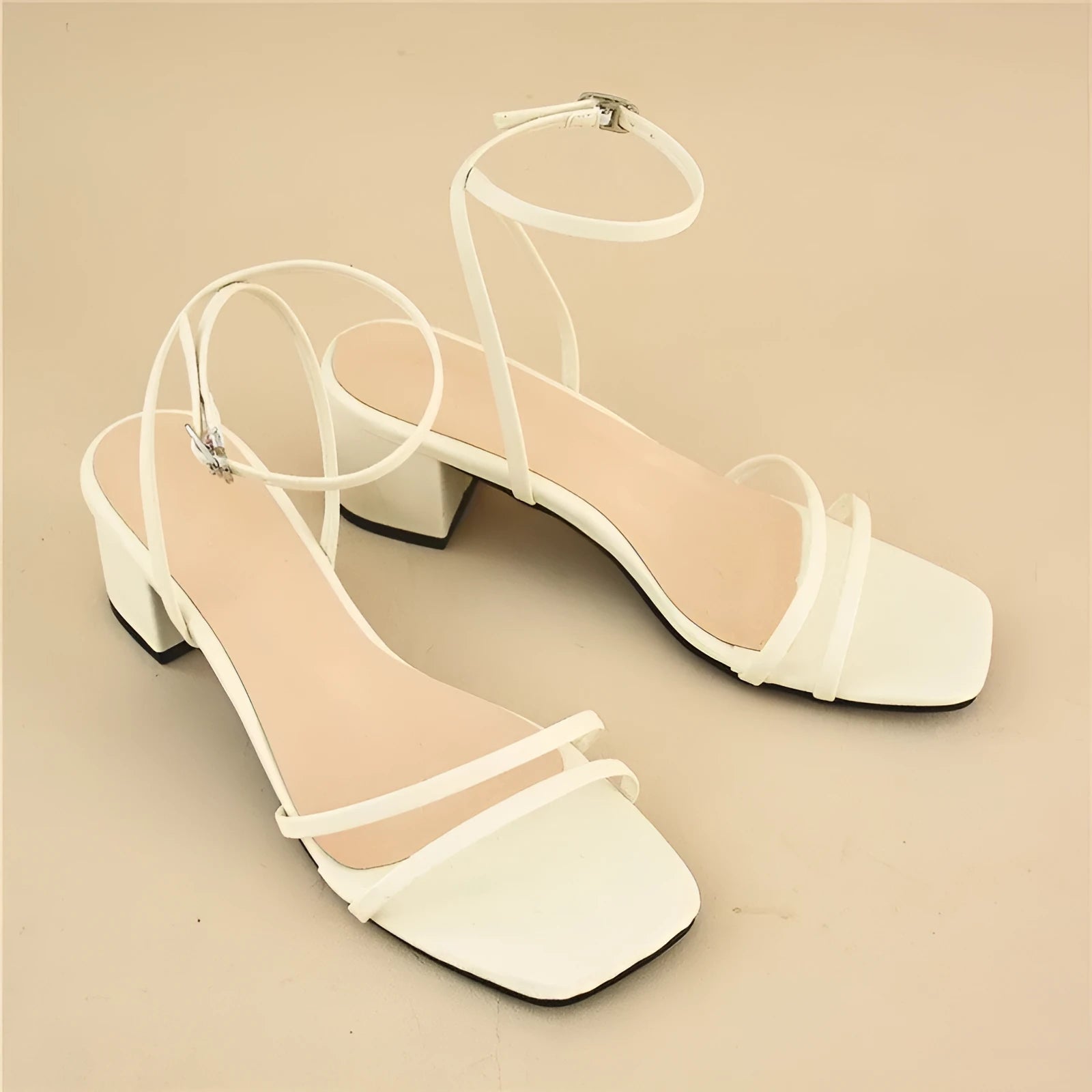 Beige women's sandals with a stiletto chunky heel, square toe, and a single ankle buckle.