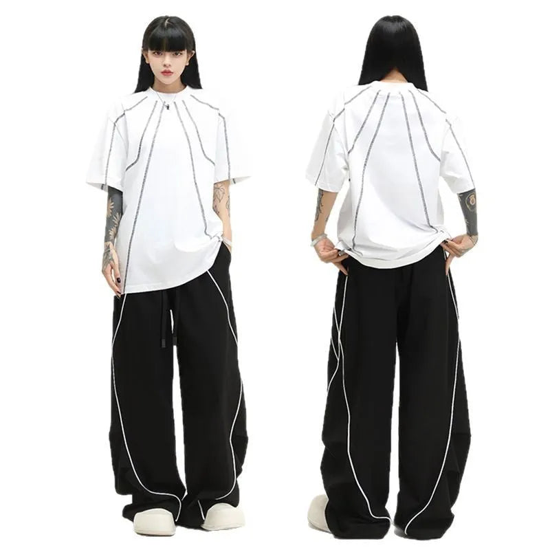 Black pleated wide-leg hip hop trousers with stripe pattern showing loose fit design