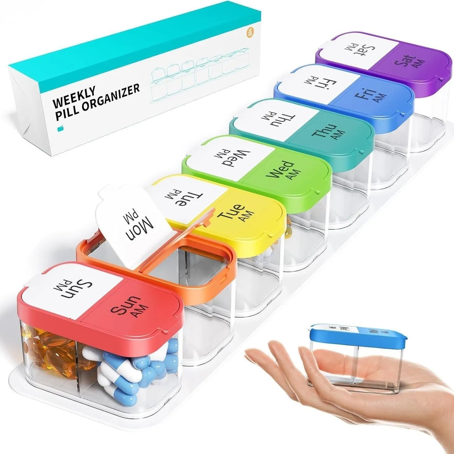Extra large white and rainbow plastic pill organiser box with 14 removable grid compartments open on a table.
