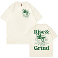 Man wearing a loose grey linen t-shirt with a Rise and Grind Green Coffee cartoon print design.