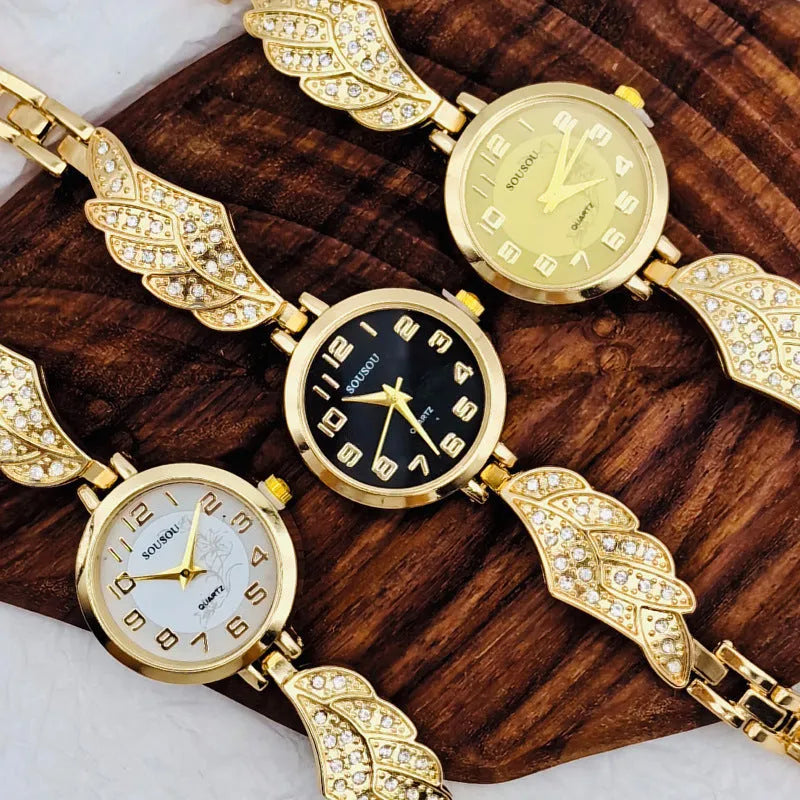 Stainless steel women's watch with round dial on wrist, showing gold colour surface and vachette clasp.
