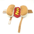 Small dog wearing red hot dog costume with adjustable belly strap