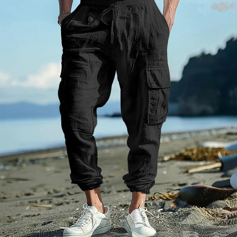 Men's ankle-tied linen trousers in Army Green colour showing multi-pocket design and drawstring waist