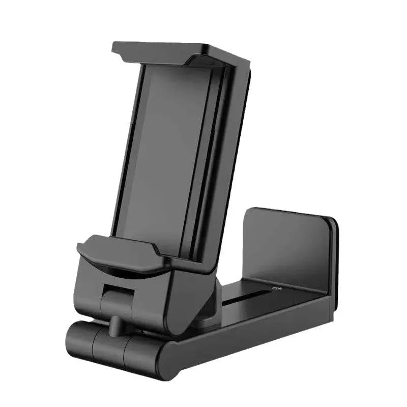 Black 360-degree rotating collapsible phone holder on desktop showing adjustable viewing angles
