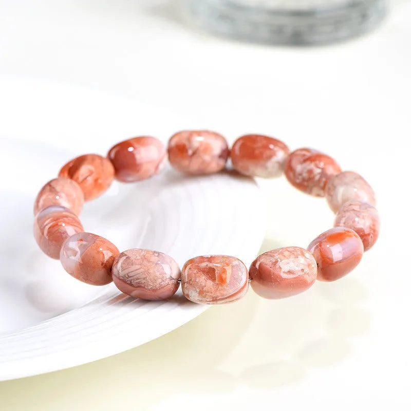 Natural cherry agate bracelet with 10x14mm barrel beads and Ruyi geometric elements