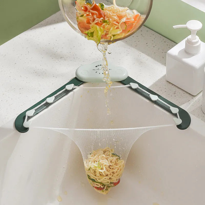 Triangular grey sink drain rack with mesh filter bag in kitchen sink corner