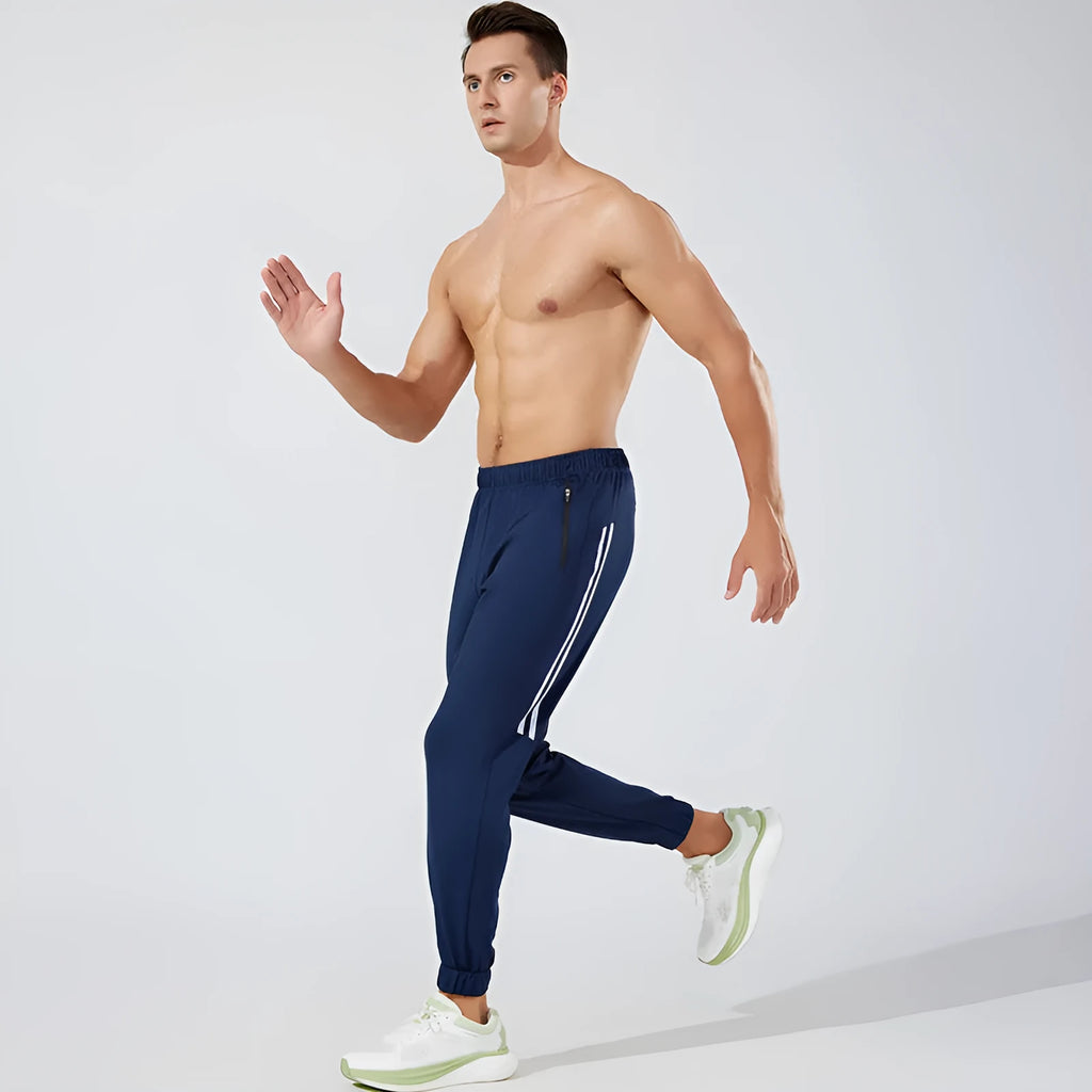 Man wearing black mid-waist polyester running pants for exercise.