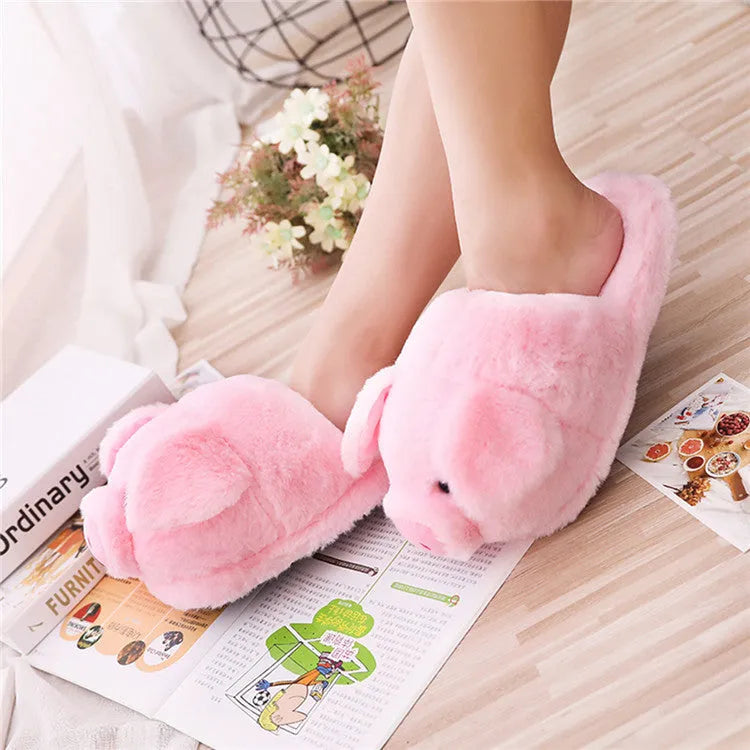 Pink pig-shaped plush floor slippers with short plush exterior.