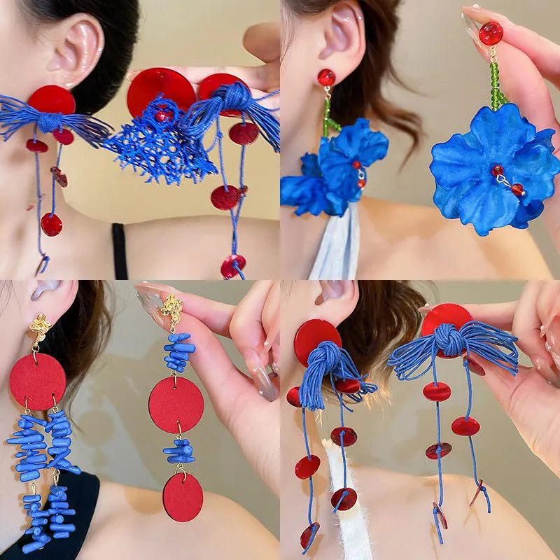 Handcrafted geometric cloth earrings with blue resin flower and silver needle detailing