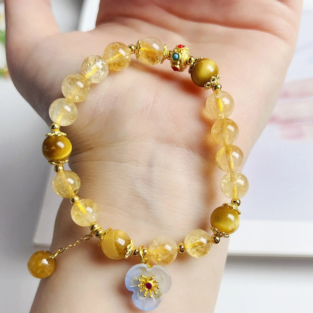 Golden yellow citrine crystal bracelet with flower and tassel detail for women.