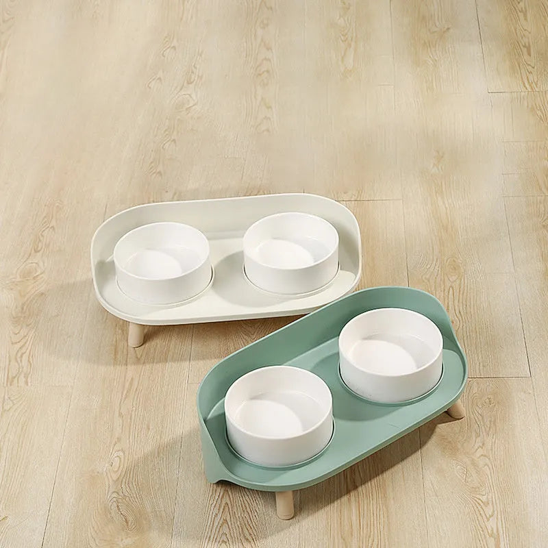 Green adjustable tilted double pet bowl for cats and dogs, showing separate food and water compartments.