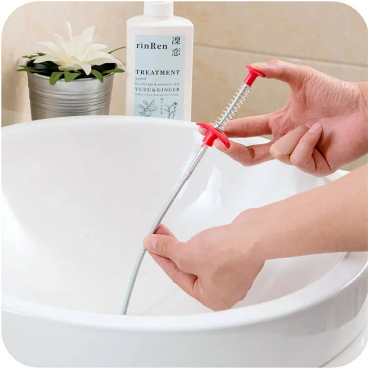 Black flexible sewer dredger spring drain cleaning tool with a textured grip on a white background.