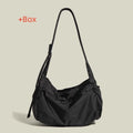 Large black nylon waterproof messenger bag with a single shoulder strap, shown open to reveal internal organisation.