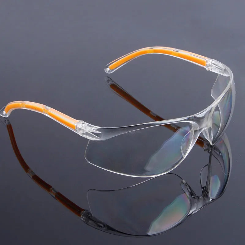 Transparent safety goggles with yellow tinted polycarbonate lenses for lab and welding protection.