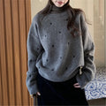 Loose beige women's pullover sweater with crew neck, long sleeves, and chest embroidery.