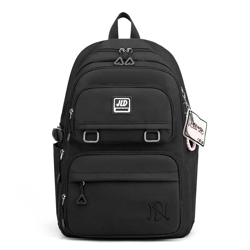 Girls' large purple nylon school backpack with a curved back panel, shown alongside blue and graphic print versions.