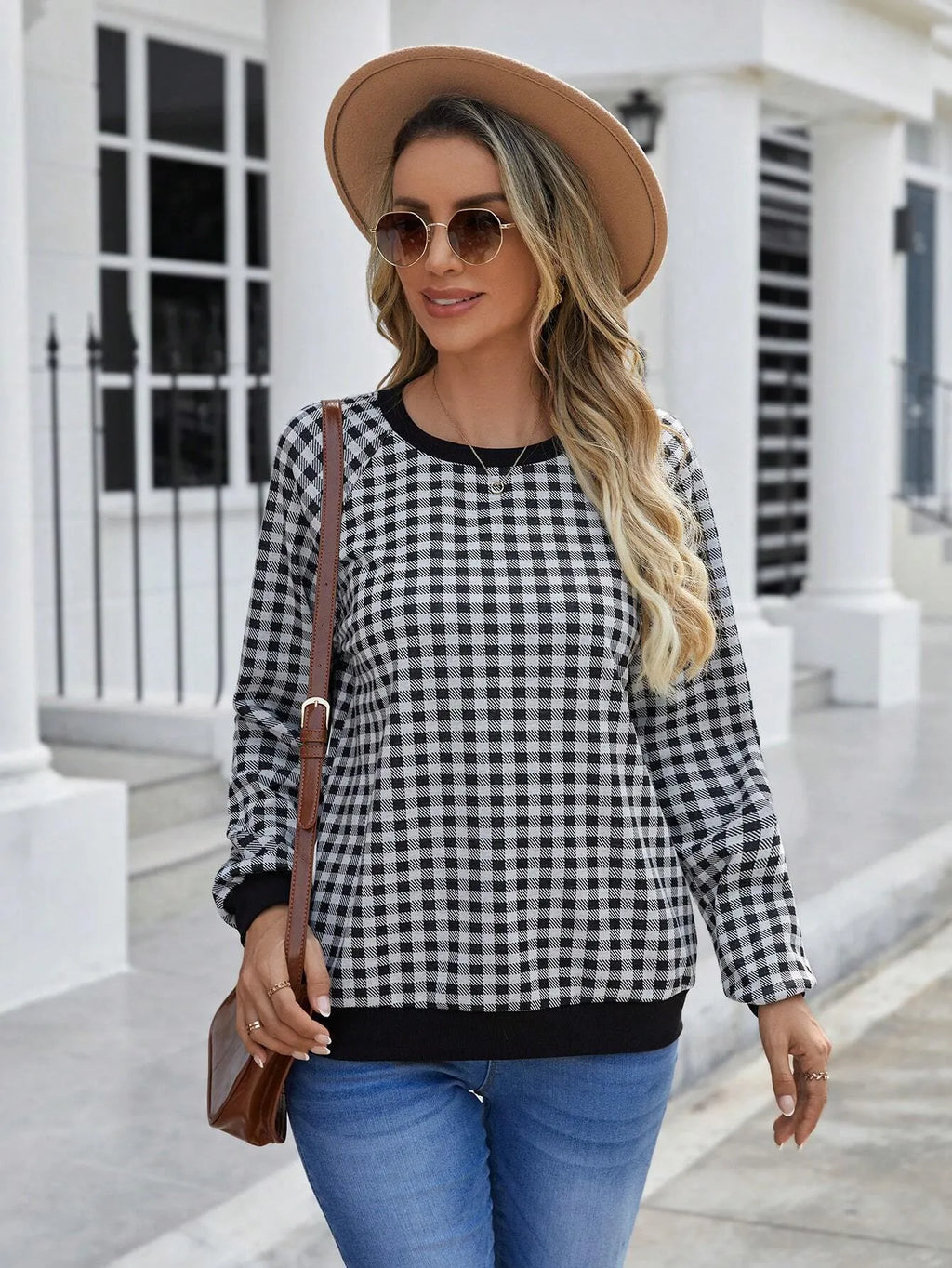 Black long sleeve pullover sweater with a striped plaid pattern, showing regular sleeve cut.