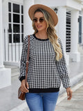 Black long sleeve pullover sweater with a striped plaid pattern, showing regular sleeve cut.