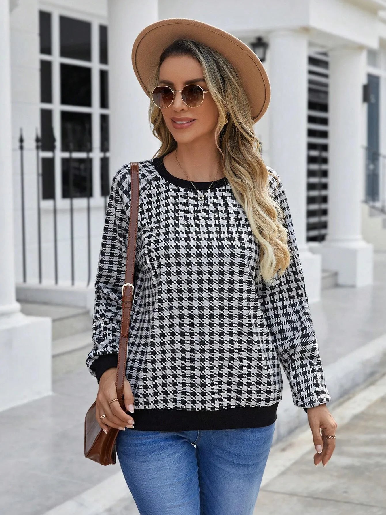 Black long sleeve pullover sweater with a striped plaid pattern, showing regular sleeve cut.