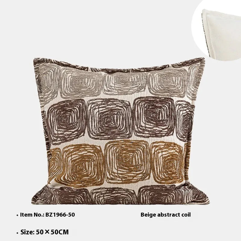 Cream and coffee-coloured abstract coil pattern square pillow cover 50x50cm on a grey sofa.